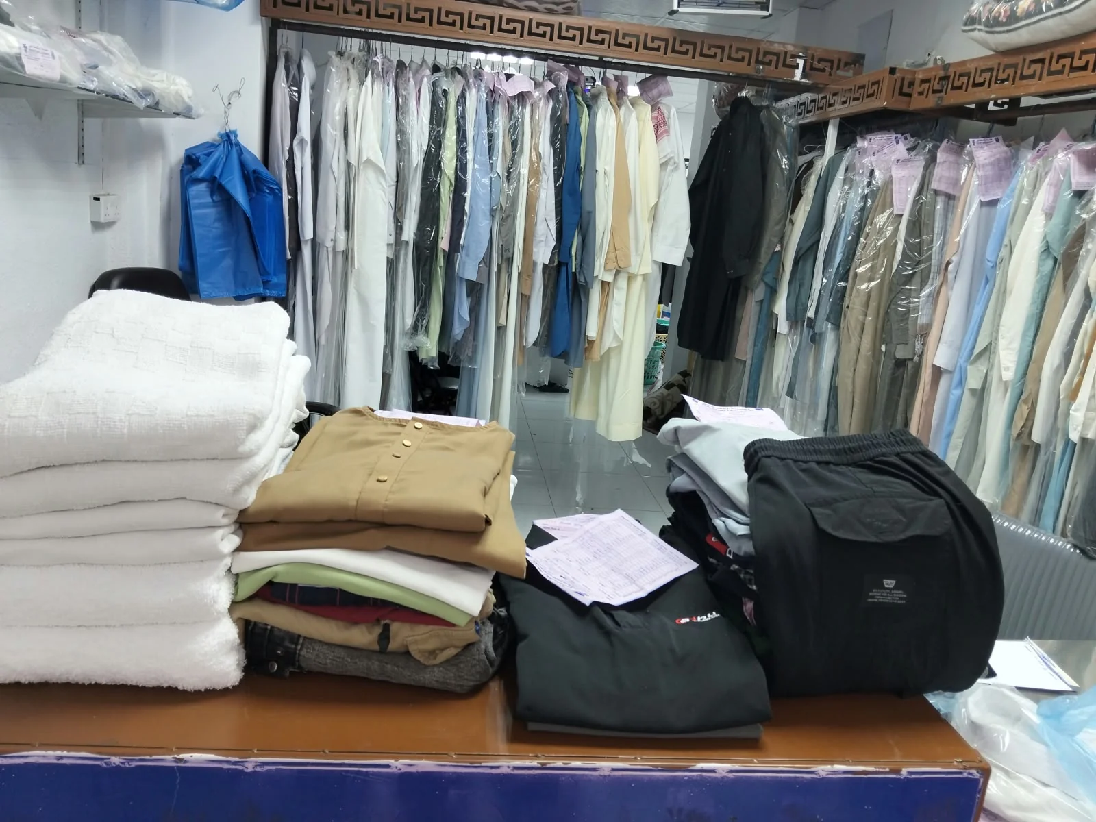 Folded clothes and prepared garments on the laundry counter