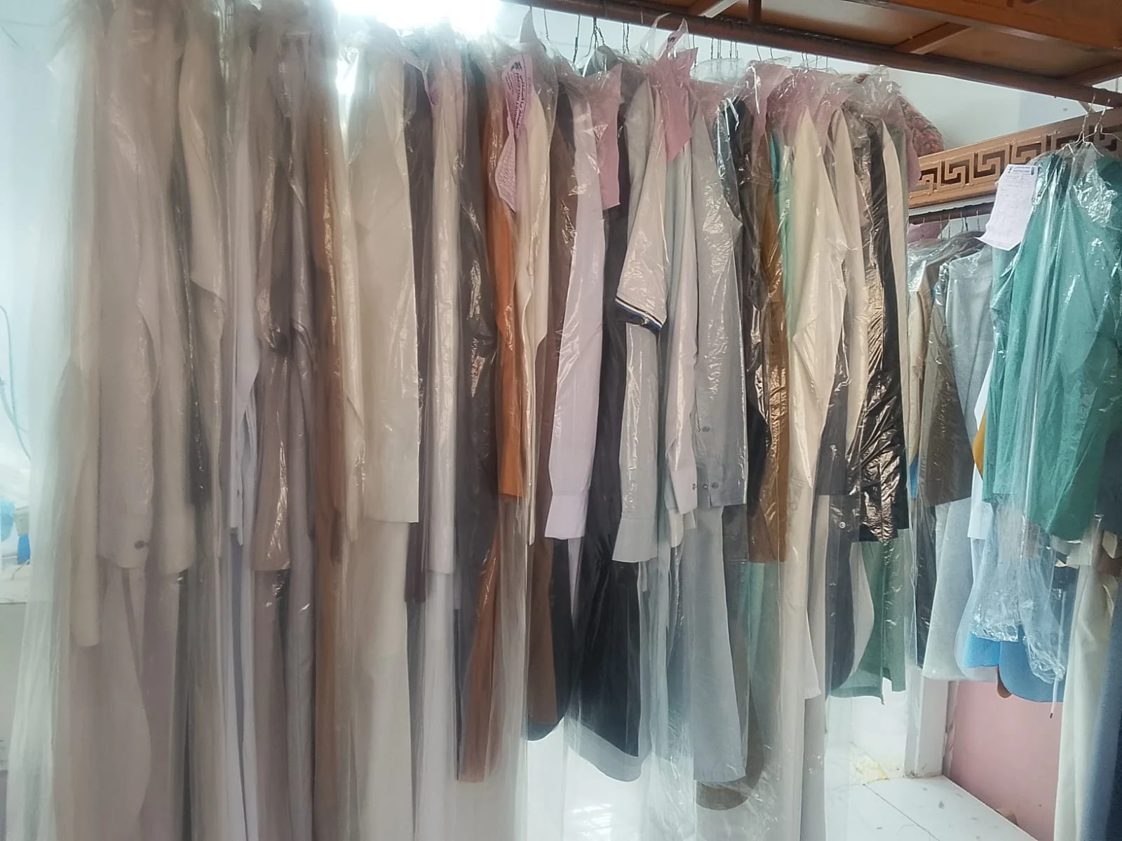 Individual garments neatly hung and covered inside Azdahar